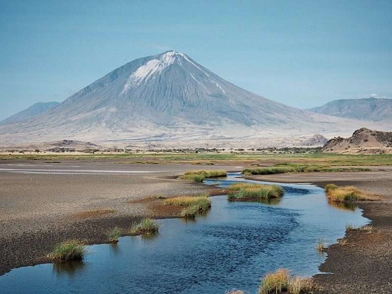 Panoramic view of Lake Natron with flamingos and Ol Doinyo Lengai